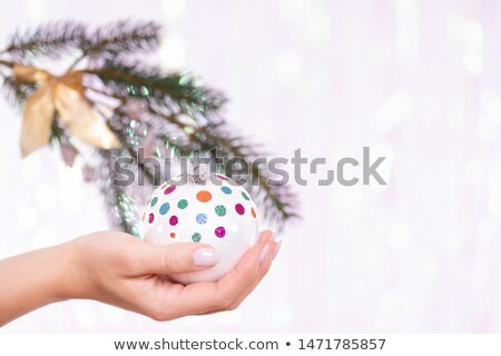 [[stock_photo]]: Woman Hanging Silver Christmas Ball On Fir Tree Holiday Concept