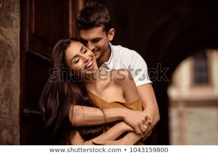 [[stock_photo]]: Pretty Couple Cuddling Outdoors And Smiling