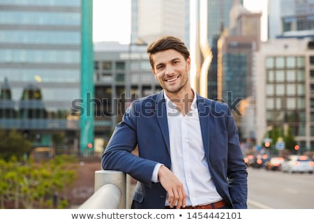 Foto stock: Smiling Businessman Dressed In Shirt Standing Outdoors