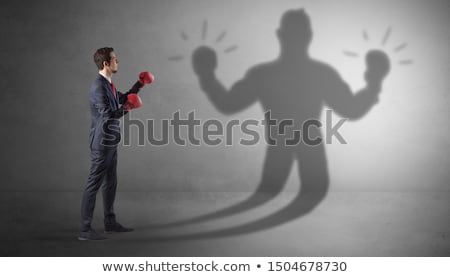 Foto stock: Businessman Fighting With His Unarmed Shadow