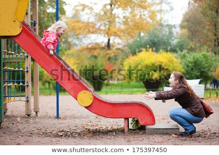 Foto stock: Mother And Kid On Slide