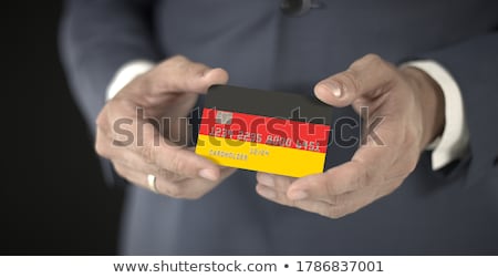 Stock photo: German Businessman Holding Business Card With Germany Flag