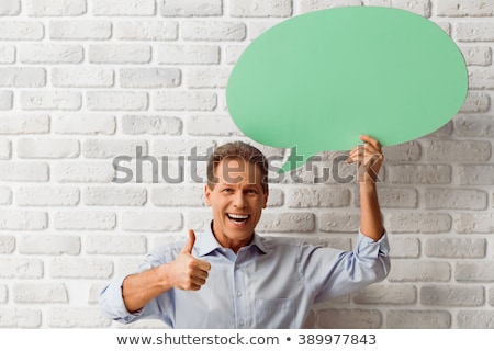 Foto stock: Business People Text Messaging Against Brick Wall