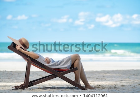 Stockfoto: Blurred Image Tourist Woman On The Beach