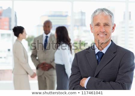 Stock fotó: Businessman Standing With His Arms Crossed And Smiling