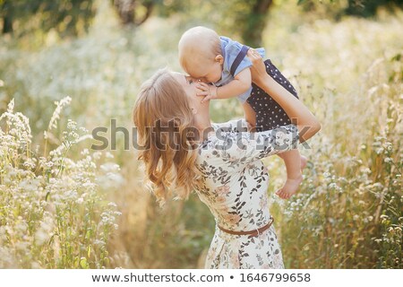 Foto d'archivio: Young Beautiful Woman With Her Child Outdoors
