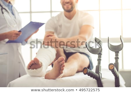 Stockfoto: Injured Doctor With Broken Leg