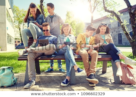 Сток-фото: Teenage Students With Tablet Pc At School Yard
