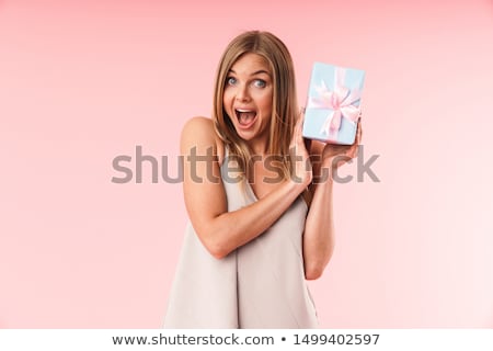 Foto stock: Beautiful Happy Young Emotional Woman Posing Isolated Over Pink Background Holding Gift Boxes Wearin