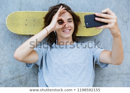 Сток-фото: Top View Of A Smiling Young Teenge Boy Spending Time