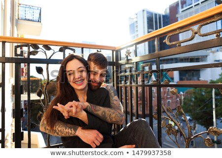 Stok fotoğraf: Young Tattooed Stylish Couple Hugging In Bedroom