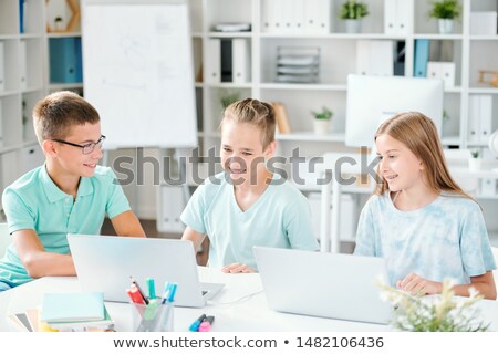 Group Of Contemporary Schoolkids Watching Online Video On Laptop Foto stock © Pressmaster