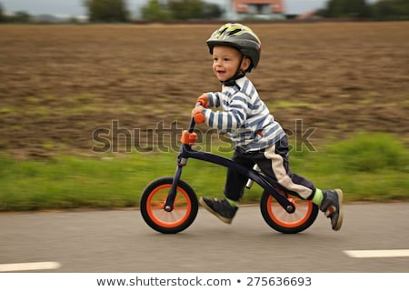 Foto stock: Little Boy On A Bicycle Caught In Motion On A Driveway Motion Blurred Preschool Childs First Day