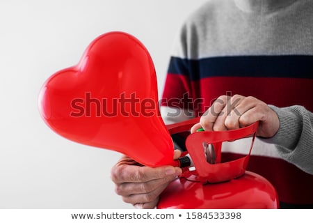 Stock foto: Inflating A Heart Shaped Balloon From A Cylinder