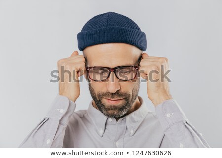 Foto d'archivio: Close Up Shot Of Stressful Unshaven Man Keeps Hand Near Temples Has Terrible Headache Suffers From