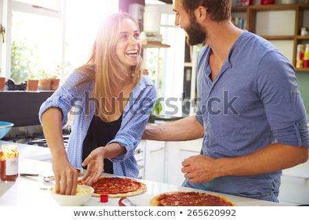 Сток-фото: Young Man In Kitchen With Homemade Pizza