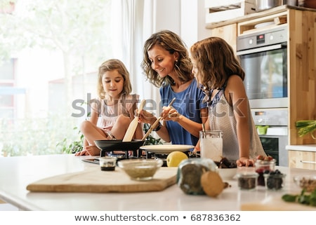 Stock photo: Mother And Daughter Making Crepes Together
