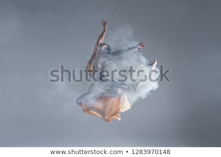 Stok fotoğraf: Young Beautiful Dancer In Beige Dress Dancing On Gray Background