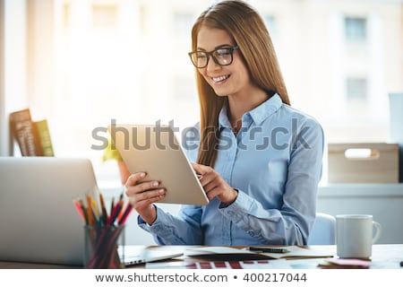 Foto stock: Cheerful Attractive Young Woman Using Tablet Computer