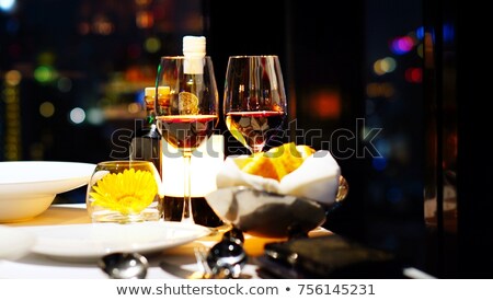 ストックフォト: Wineglass With Red Wine On A Diner Table