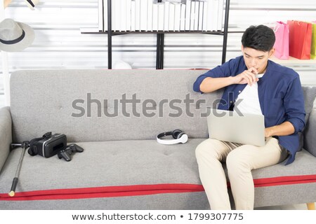 Stock foto: Young Asian Businessman Sitting Relaxed On Sofa Thinking Work An