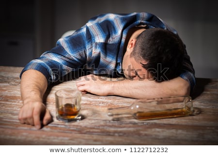 Stock photo: Drunk Man With Glass Of Alcohol On Table At Night