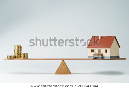 ストックフォト: Model House And Stack Of Coins On Seesaw