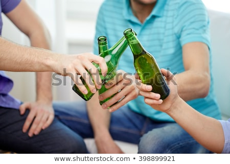 Stok fotoğraf: Friends Drinking Non Alcoholic Beer At Home
