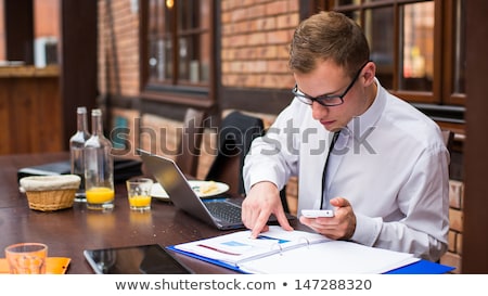 Stok fotoğraf: Hard Working Businessman In Restaurant Close Up