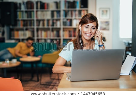Foto stock: Two Female College Students Working On A Laptop Computer
