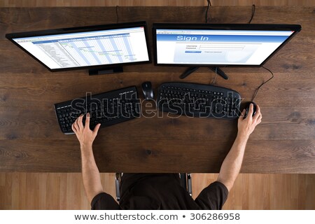 Stock photo: Man With Computers Showing Gantt Diagram And Signin App