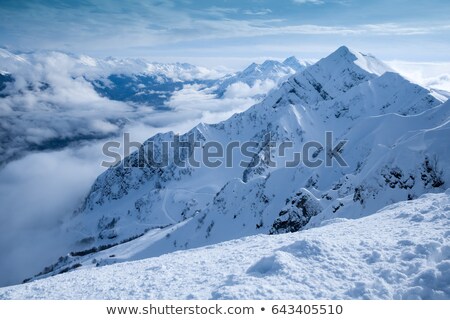 Foto stock: Severe Mountains Ridge Covered By Snow In The Shiny Sunny Day