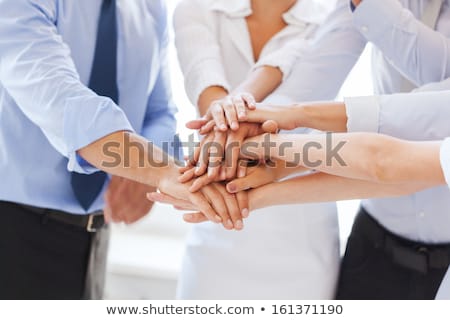 Foto stock: Happy Business Team At Office Party Holding Hands