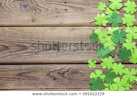 Foto d'archivio: Green Paper Four Leaf Clover On Wooden Background