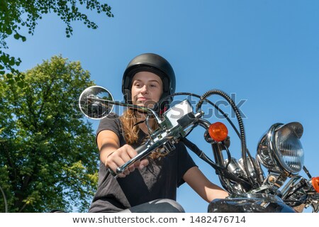 Stok fotoğraf: Woman Looking In Rearview Mirror Of A Scooter