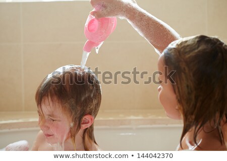 ストックフォト: Two Girls Sharing Bubble Bath And Washing Hair