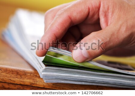 Stock photo: The Hand Through The Pages Of The Magazine