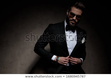 Zdjęcia stock: Model In Black Tux With Bowtie Posing In Dark Studio