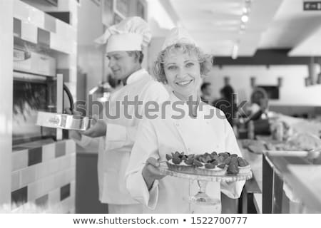 Foto stock: Young Woman Looking At Strawberry Tart