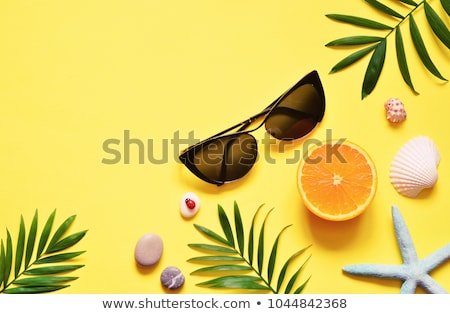 Сток-фото: Starfish With Tropical Palm Branches On Yellow Background