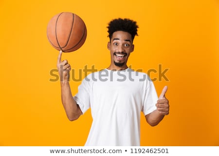 Stock fotó: Smiling Young Man Spinning Ball On Finger