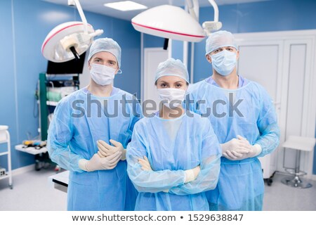 Stockfoto: Three Contemporary Professionals In Protective Masks Gloves And Uniform