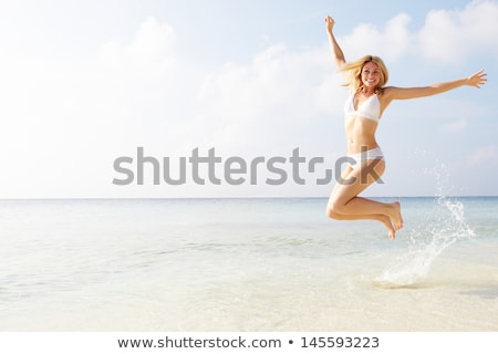 Stockfoto: Happy Woman Jumping On The Beach