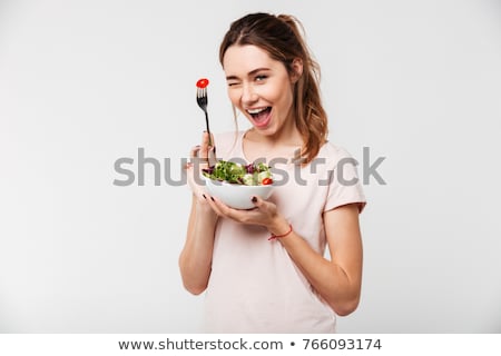 Stockfoto: Happy Woman Is Eating A Salad