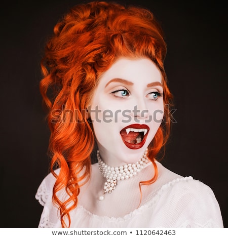 Foto stock: Woman Vampire With Fangs On A Black Background