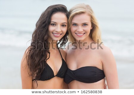 Stockfoto: Two Beautiful Women In Bikinis Relaxing On Beach