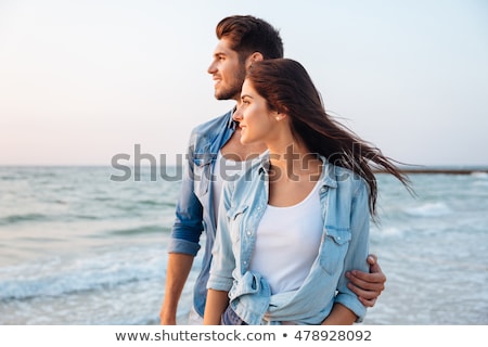 Сток-фото: Beautiful Young Couple Looks Away