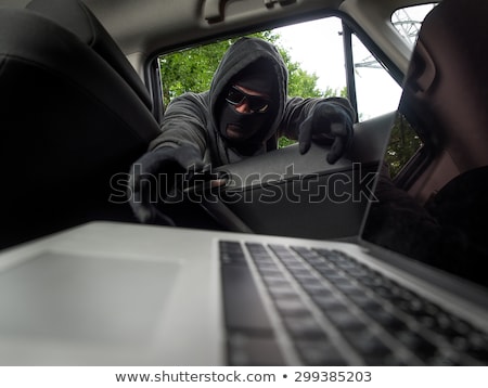 Сток-фото: Thief Stealing Laptop From The Car
