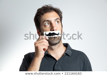 Foto d'archivio: Holding A Fake Mustache