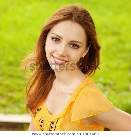 Stock photo: Attractive Girl Smiles And Sits On Bench